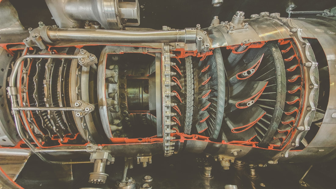 A&P students examining the inside of a jet engine